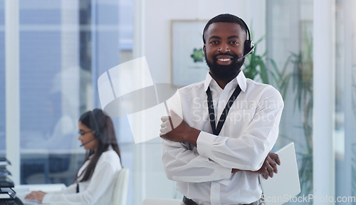 Image of Call center, portrait or black man with arms crossed in customer service, support or telemarketing office. Employee, businessman or crm consultant with tablet, technology or contact us for advice