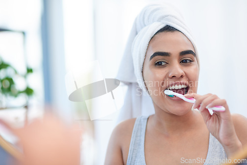 Image of Toothpaste, woman and toothbrush for cleaning teeth, dental health or morning shower in bathroom. Girl, face in mirror and washing mouth with tooth brush, hygiene and smile for health and wellness