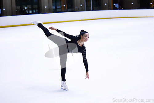 Image of Sport, woman athlete figure skating and at a sports arena on ice floor. Fitness training or exercise, balance or health wellness and female person skate for competition or tournament in sportswear