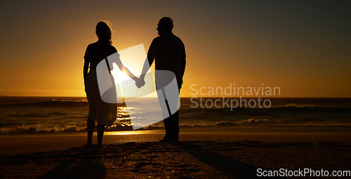 Image of Beach, sunset and a silhouette couple holding hands on vacation or holiday outdoor. Behind man and woman in nature with creative art, mockup space and ocean for love, care and travel or freedom