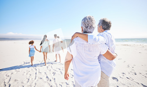 Image of Big family, sea or old couple walking with children in summer with happiness, trust or peace in nature. Grandparents, back view or senior man bonding with woman or kids taking a walk on beach sand