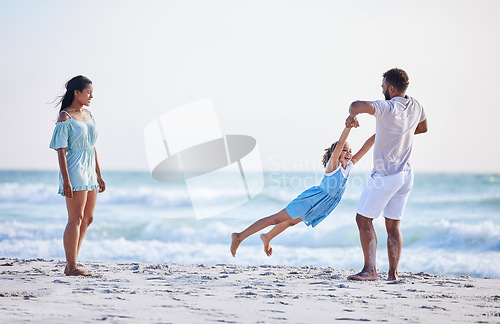 Image of Mother, beach or father playing with child in air on family holiday, vacation or weekend break together. Parents, mom or dad swinging or bonding with child, daughter or kid at seaside with happiness