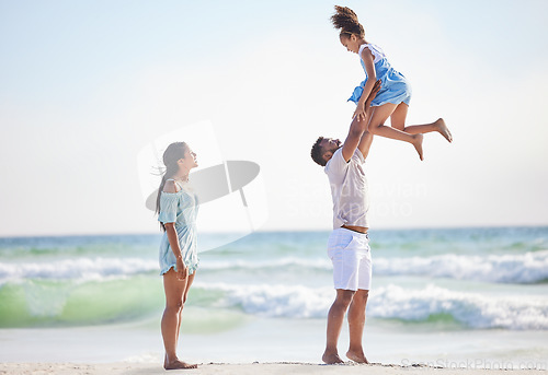 Image of Mother, beach or father playing a girl in air on a family holiday, vacation or weekend break together. Parents, mom or dad swinging or bonding with child, daughter or kid at seaside with happiness