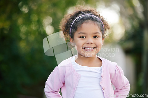 Image of Happy, smile and portrait of a kid in a garden with joy, positive emotion and childhood growth. Happiness, excited girl and face of cute child from Mexico standing outdoor in park with mockup space