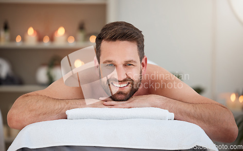 Image of Portrait, relax and massage with a man lying in spa for wellness treatment at a luxury resort for health. Bed, care or beauty and a happy male customer smile for stress relief with aromatherapy