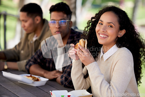 Image of Students, smile and friends eating a burger together in university or college campus for a break meal. Happy, portrait and woman with group of young people with food, lunch or relax in a restaurant