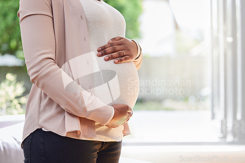 Image of Pregnant, stomach and woman frame her belly or ready for motherhood or hands on tummy in the living room at home. Maternity, pregnancy and female abdomen for family planning or prenatal or life