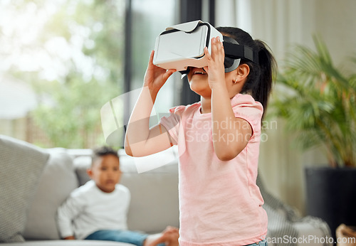 Image of Young girl with VR goggles, gaming and metaverse with futuristic tech, child experience simulation at family home. Female kid in living room with video games, virtual reality and future technology