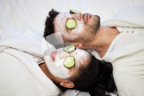 Image of Facial, spa and relax with couple and mask for skincare, cosmetics and detox treatment. Beauty, face and self care weekend with man and woman in bedroom at home for salon, wellness and cucumber