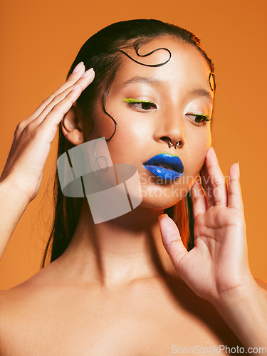 Image of Neon makeup, beauty and portrait of woman in studio for cosmetics, eye shadow and aesthetic. Creative design, cosmetology and face of female person with blue lipstick for glamour, fashion and style