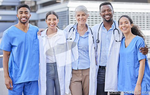 Image of Doctor team, city and hug with diversity and happy nurse from healthcare and wellness work. Urban, nursing and clinic group with doctors and support with success, motivation and smile outdoor