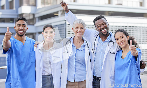 Image of Doctor team, city and thumbs up with hug and celebration for healthcare and wellness work. Hospital, nursing and happy clinic group with success and support together with smile, motivation and trust