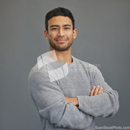 Image of Portrait of happy man with mockup, arms crossed and ideas on studio backdrop in casual fashion. Relax, confidence and face of male on grey background with happiness, pride and smile with promo space.