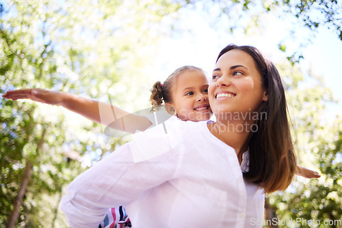 Image of Child, mother and family outdoor in nature for piggyback in summer with happiness, love and care. Woman and girl kid playing together with arms out at a park for adventure, quality time and freedom