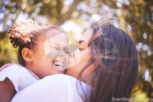 Image of Mother, child and kiss cheek in nature, funny and bonding in summer garden on holiday. Mom kissing happy girl for love, affection and care of enjoying freedom of quality time together outdoor in park