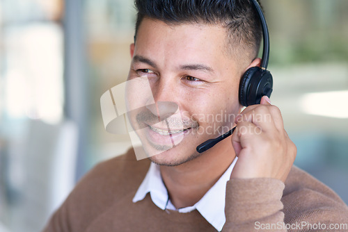 Image of Man, face and callcenter with CRM and contact us, communication with headset and phone call in office. Male consultant smile in customer service, telemarketing or tech support with help desk job