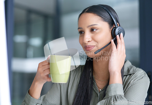 Image of Woman with coffee, call center with CRM and contact us, communication with headset and technology in office. Female consultant with drink, customer service or telemarketing with help desk job