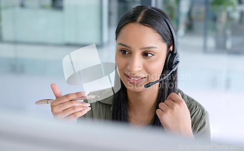 Image of Woman, phone call at callcenter with CRM and contact us, communication with headset and technology in office. Female consultant in customer service, telemarketing or tech support with help desk job