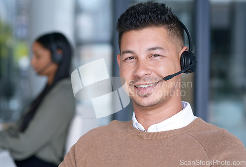 Image of Man with smile in portrait, call center with CRM and contact us, communication with headset and technology in office. Male consultant, face with customer service or telemarketing with help desk job