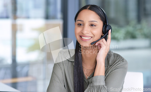 Image of Woman with smile, callcenter with CRM and contact us, communication with headset and phone call in office. Female consultant in customer service, telemarketing or tech support with help desk job