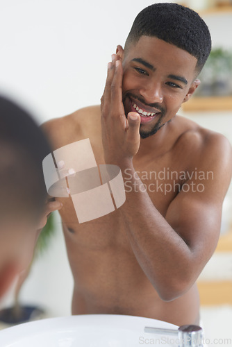 Image of Happy man, face and beauty with mirror and skincare, hygiene and grooming during morning routine at home. Black male person smile in bathroom, fresh and clean facial with wellness and moisturizing