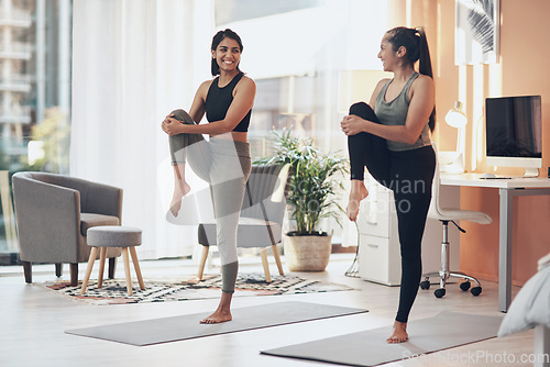 Image of Friends, exercise and women stretching together in a house with a smile, health and wellness. Indian sisters or female family in a home while happy about workout, yoga and fitness with a partner