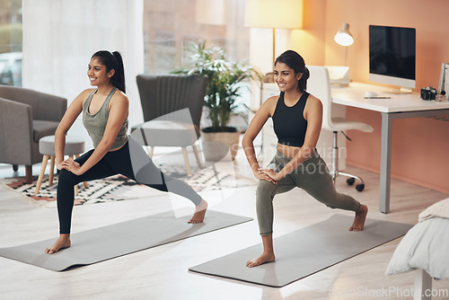 Image of Women, yoga and friends exercise in a house together with smile, health and wellness. Indian sisters or female family in a lounge while happy about workout, stretching and fitness with a partner