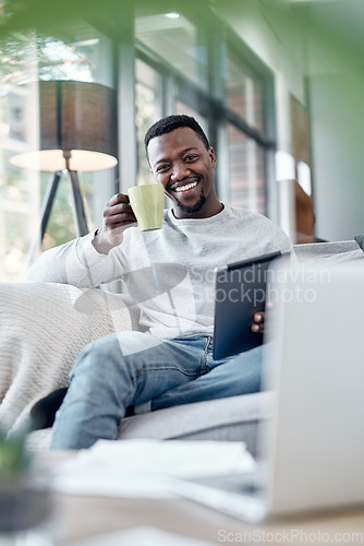 Image of Portrait, coffee and tablet with a black man on a sofa, sitting in the living room of his home to relax. Smile, technology and internet with a happy person relaxing in a house to browse social media