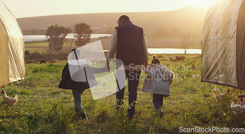 Image of Family, holding hands and a man walking on a farm with his kids for agriculture or sustainability. Back, farming and a father with children in meadow as a cow farmer in natural countryside at sunset