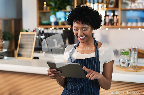 Image of Happy woman, tablet and waitress at cafe for order, inventory or checking stock at restaurant. Female person, barista or employee on technology in small business for online service at coffee shop