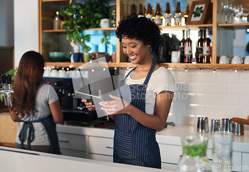Image of Happy woman, tablet and waitress in management at cafe for order, inventory or checking stock at restaurant. African female person, barista or manager on technology for small business at coffee shop