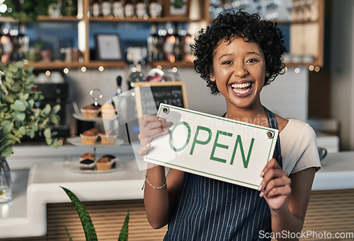 Image of Happy woman, open sign and portrait of waitress at cafe in small business, morning or ready to serve. Female person, restaurant owner or server holding board for coffee shop or cafeteria opening