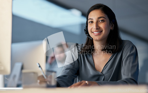 Image of Call center, portrait and woman writing notes for customer service, sales consulting and CRM in office at night. Happy female agent, consultant and contact us for telemarketing, online help or advice