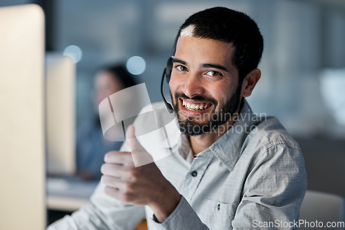 Image of Call center, portrait and man with thumbs up for customer service, sales target and CRM success in office. Happy consultant, thumb and yes emoji of winning support, excellence and good telecom advice