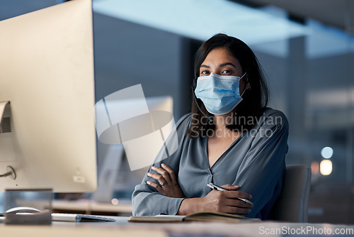 Image of Call center, portrait and woman with mask at computer in office for customer service, consulting and CRM support at night. Female agent, consultant and virus protection for telemarketing at help desk