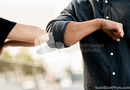 Image of Closeup, man and woman elbow greeting to avoid the spread of coronavirus or COVID-19 infection and outdoors. Social distancing, health and wellness or fear of pandemic or meet in the street outside