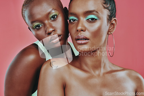 Image of Makeup art, women together and portrait in studio, beauty or cosmetic for diverse friends by background. Creative black woman, model girl and neon color for support, skin glow or futuristic aesthetic