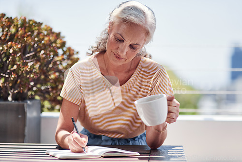 Image of Writing, book and an old woman author sitting outdoor in summer for inspiration as a writer. Idea, planning and a senior female pensioner drinking coffee while using a pen to write in her diary