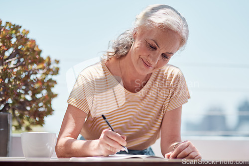 Image of Writing, book and a senior woman author sitting outdoor in summer for inspiration as a writer. Idea, planning and notebook with a female journalist using a pen to write in a journal or diary outside