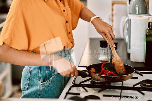 Image of Kitchen, closeup and woman hands cooking with a pan for lunch, dinner or supper in apartment. Nutrition, and female person preparing healthy, vegetarian or diet food or meal on the stove in her home.