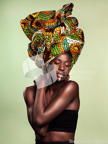 Image of Beauty, black woman fashion and cosmetics with African head wrap and makeup in studio. Isolated, green background and young female person with a traditional hair scarf with confidence and culture