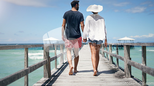 Image of Couple, walking and Maldives pier on a tropical island on vacation with freedom by sea. Ocean, beach and deck walk of man back and woman together with love in summer on a holiday outdoor in sun