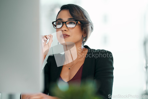 Image of Computer, research and business woman in glasses reflection for reading, online review or editor analysis. Focused Latino person or professional worker in website editing or analytics on desktop pc