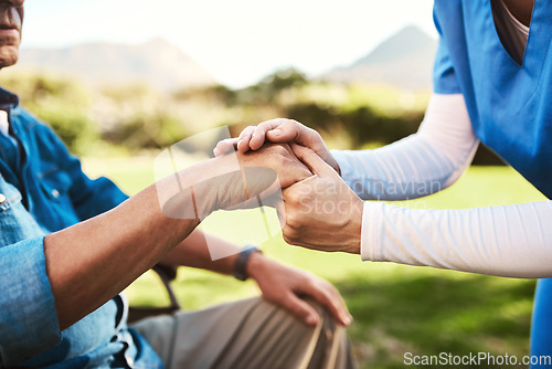 Image of Senior, nurse and holding hands in wheelchair for healthcare support, love or elderly care compassion in nature. Hand of caregiver helping man patient or person with a disability outside nursing home