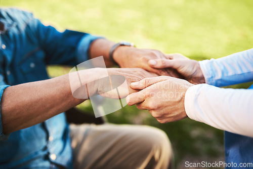 Image of Senior, nurse and holding hands in wheelchair for elderly support, healthcare or life insurance in nature. Hand of caregiver helping male patient or person with a disability outside nursing home