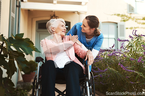 Image of Senior woman, wheelchair and nurse in healthcare support, talking or garden walk at nursing home. Happy elderly female and caregiver helping patient or person with a disability, health or retirement