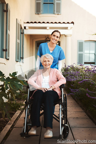 Image of Senior woman, wheelchair and portrait of caregiver in healthcare support or garden walk at nursing home. Happy elderly female and nurse helping patient or person with a disability by retirement house