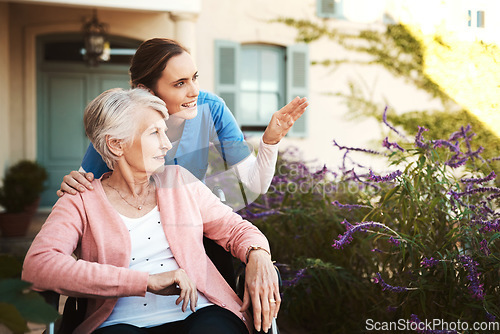 Image of Senior woman, wheelchair and nurse in garden pointing and talking on walk in healthcare support at nursing home. Happy elderly female or caregiver showing patient or person with a disability outdoors