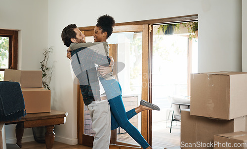 Image of Happy interracial couple hug in new home for property relocation, renovation or investment together. Excited man embrace woman in real estate, house and boxes for moving, mortgage loan or celebration