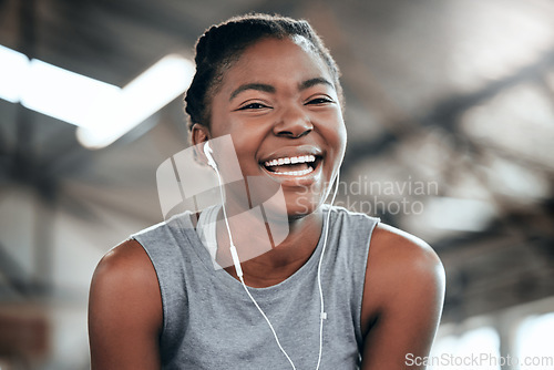 Image of Happy, portrait or black woman with headphones in gym to workout, exercise or training for wellness. Face of sports girl or healthy fitness athlete laughing with positive mindset listening to music